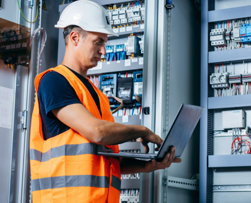 Adult Electrician Builder Engineer Testing And Screwing Equipment In Fuse Box