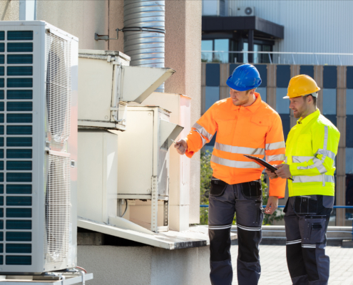 Two Men Inspecting Commercial Hvac Unit